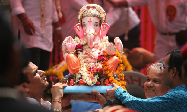 Lord Ganesh is carried by devotees in a religious procession in New Delhi. Photograph: Getty Images
